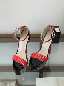 Detail of red and black patent leather platform sandals with 16cm stiletto heel