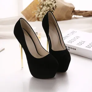 Close-up of black suede platform pumps with elegant gold stiletto heels