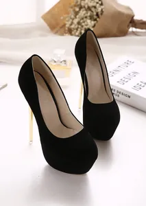 Detail view of black suede platform pumps featuring elegant gold stiletto heels