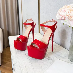Red patent leather platform sandals with extreme stiletto heels and ankle strap.
