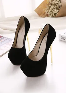 Black suede platform pumps with elegant gold stiletto heels in a studio setting.