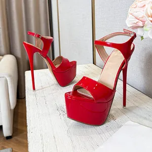 Vibrant red patent leather platform stiletto sandals with elegant ankle strap detail