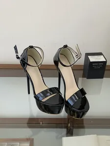 Black patent leather platform sandals with stiletto heels and adjustable ankle strap