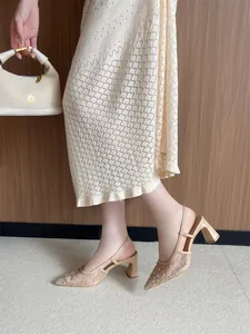 Detalle de elegantes zapatos de encaje con tacón bloque, tira trasera y detalles de perlas