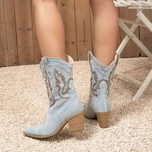 Women's light blue denim western cowboy boots with embroidery and chunky heel.