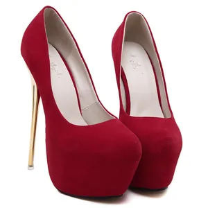 Detailed view of red suede platform pumps with high gold stiletto heels