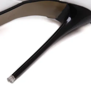 Macro detail showing the sleek black stiletto heel of an elegant women's dress shoe