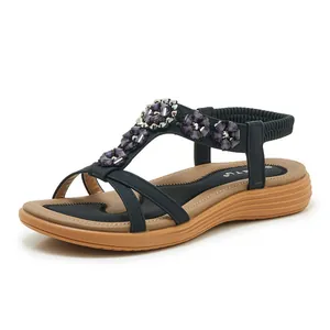 Detailed view of women's bohemian sandals with purple floral crystals and elastic back