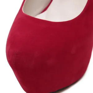 Close-up macro detail of sexy red suede platform high heel pumps showing material texture