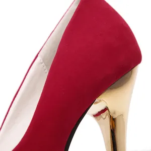 Macro detail view of red suede high heel pump with metallic gold stilettos