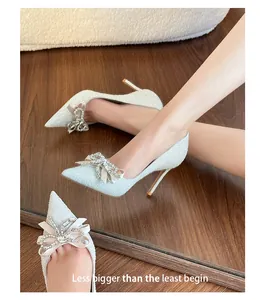 Silver glitter pointed toe wedding pumps with crystal bow detail and mirror reflection