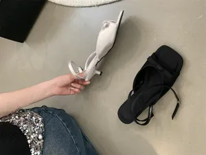 Elegant French-style kitten heel sandals with bow detailing and adjustable ankle straps