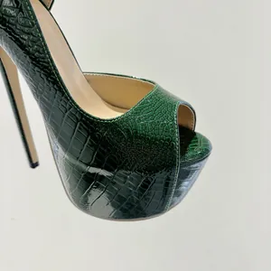 Close-up of green crocodile embossed peep-toe platform high heel shoe with stiletto