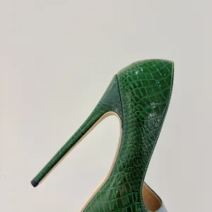 Detailed macro view of green crocodile-textured stiletto heel with a glossy finish