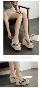Detail view of stylish platform wedge sandals with 3D floral decor and transparent uppers.