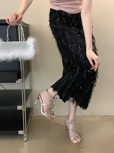 Elegant silver high heel sandals featuring sparkling rhinestone bow details worn by model