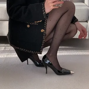 Elegant black patent leather stiletto heels with a metallic toe cap for a French look.