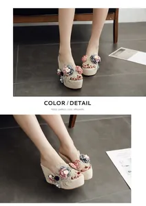 Detail view of wedge sandals featuring handmade 3D floral accents and lace details