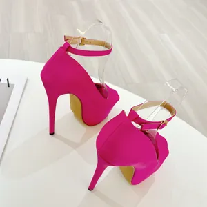 Detailed rear view showing the 16cm stiletto heel and ankle strap of magenta sandals