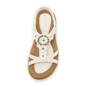Bohemian floral sandal featuring elastic back strap and rhinestone embellished flower details