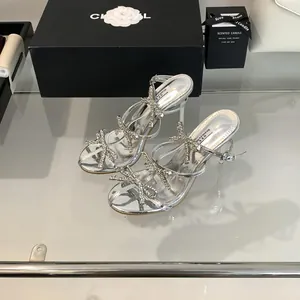 Elegant silver high heel sandals featuring multiple sparkling rhinestone bow details