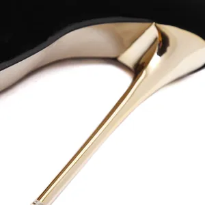Close-up of elegant gold stiletto heel on black suede high-heeled pumps