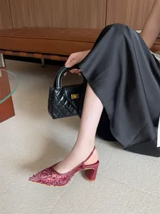 Primer plano de zapatos de tacón destalonados de encaje burdeos con punta fina en un modelo.