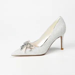 Elegant silver glitter pumps with crystal bow detail and pointed toe for weddings