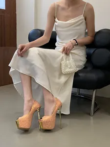 Elegance model wearing sparkling champagne peep-toe platform high heels and white dress