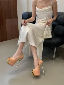 Close-up of champagne glitter platform peep-toe stiletto heels for wedding parties