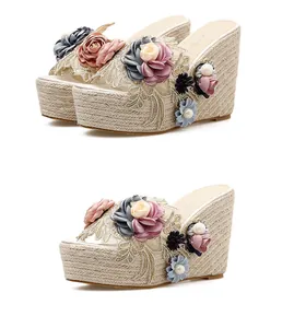 Close-up of elegant handmade floral beadwork on stylish summer platform wedge sandals