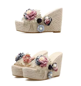 Detailed view of floral wedge sandals featuring handmade beads and pearl accents.