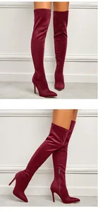Side and front view details of burgundy stretch suede over-the-knee high heel boots