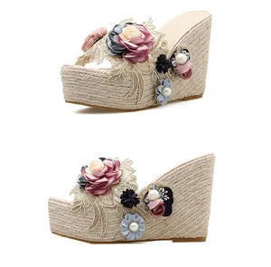 Side view of floral wedge sandals with pearl accents and woven espadrille soles.