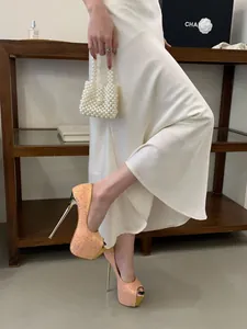 Detailed view of elegant rose gold glitter platform peep-toe stiletto heels for wedding
