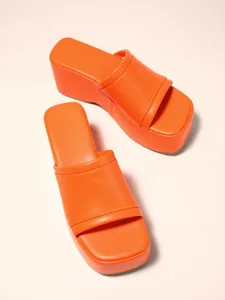 Bright orange platform wedge slides with wide strap shown from a top-down angle view