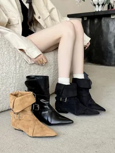 Detail showing pointed toe low heel ankle boots with buckle straps and stylish fold-over collar
