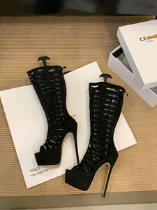 Detail view of black sexy hollow strappy Roman high heel boots with thick platform