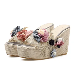 Elegant floral wedge sandals with a platform straw heel and handmade flower details