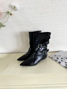 Elegant black pointed-toe short boots featuring decorative buckle straps and flat heels.