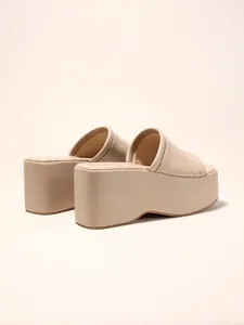 Back view of minimalist beige platform wedge slide sandals showing the thick sole detail