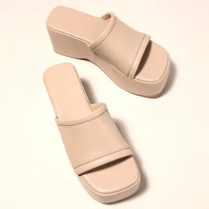 Elegant beige platform wedge slide sandals for women with a comfortable thick sole.