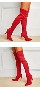 Detail view of red stretch stiletto over-the-knee boots worn by model on carpet