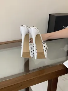 Gros plan de sandales à plateforme à pois blancs avec talons aiguilles