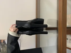 Detailed view of black 16cm ultra-high block heel and thick platform on Chelsea boots