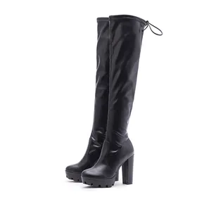 Detailed side view of black chunky high heel over-the-knee boots with platform sole