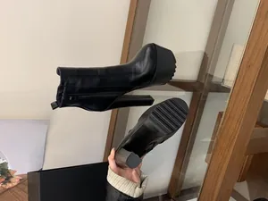 Detailed view of black 16cm chunky high heel platform ankle boots with side zipper.