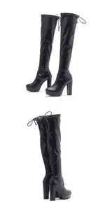 Detailed view of women's black over-the-knee boots with chunky heels and lace-up back