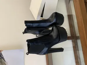 Elegant black 16cm high heel platform ankle boots with chunky heel and side zipper.