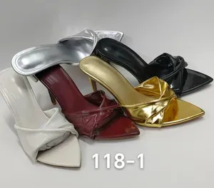 Elegant pointed-toe stiletto mules with twisted strap design shown in multiple colors